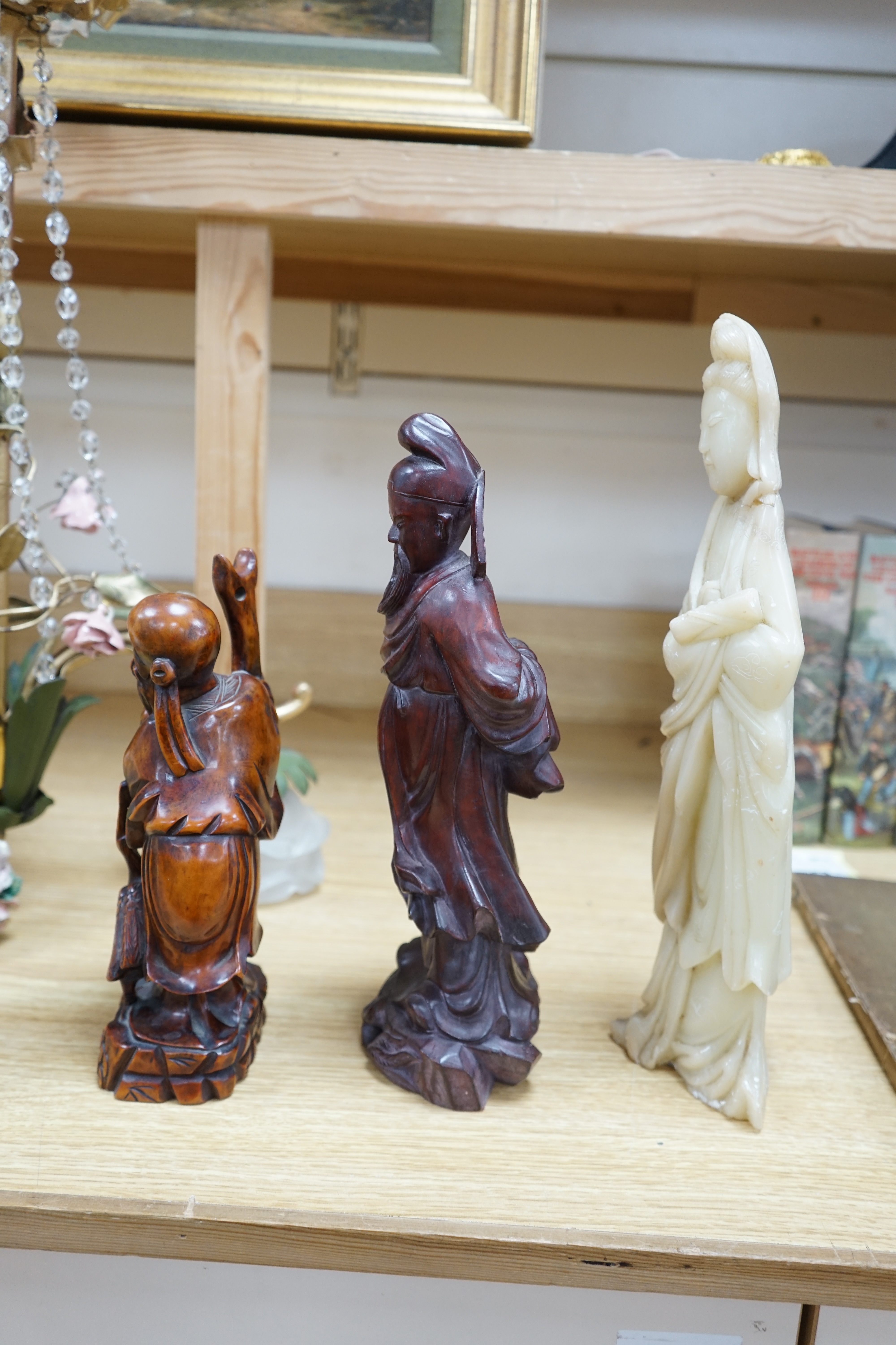 Two Chinese hardwood carved figures and a soapstone figure of Guanyin, largest 37cm high. Condition - fair